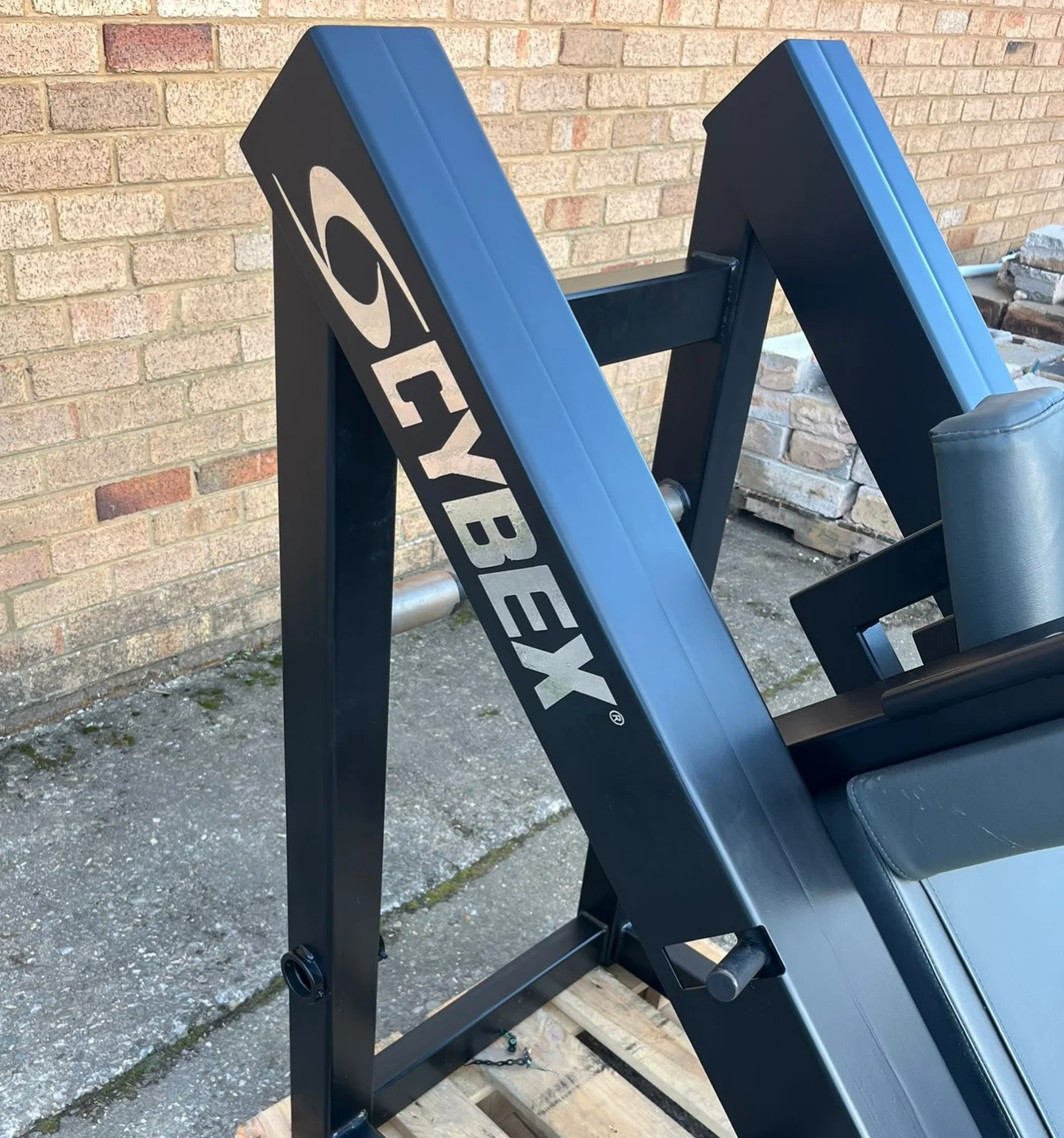 Cybex logo on the rear upright of the hack squat frame