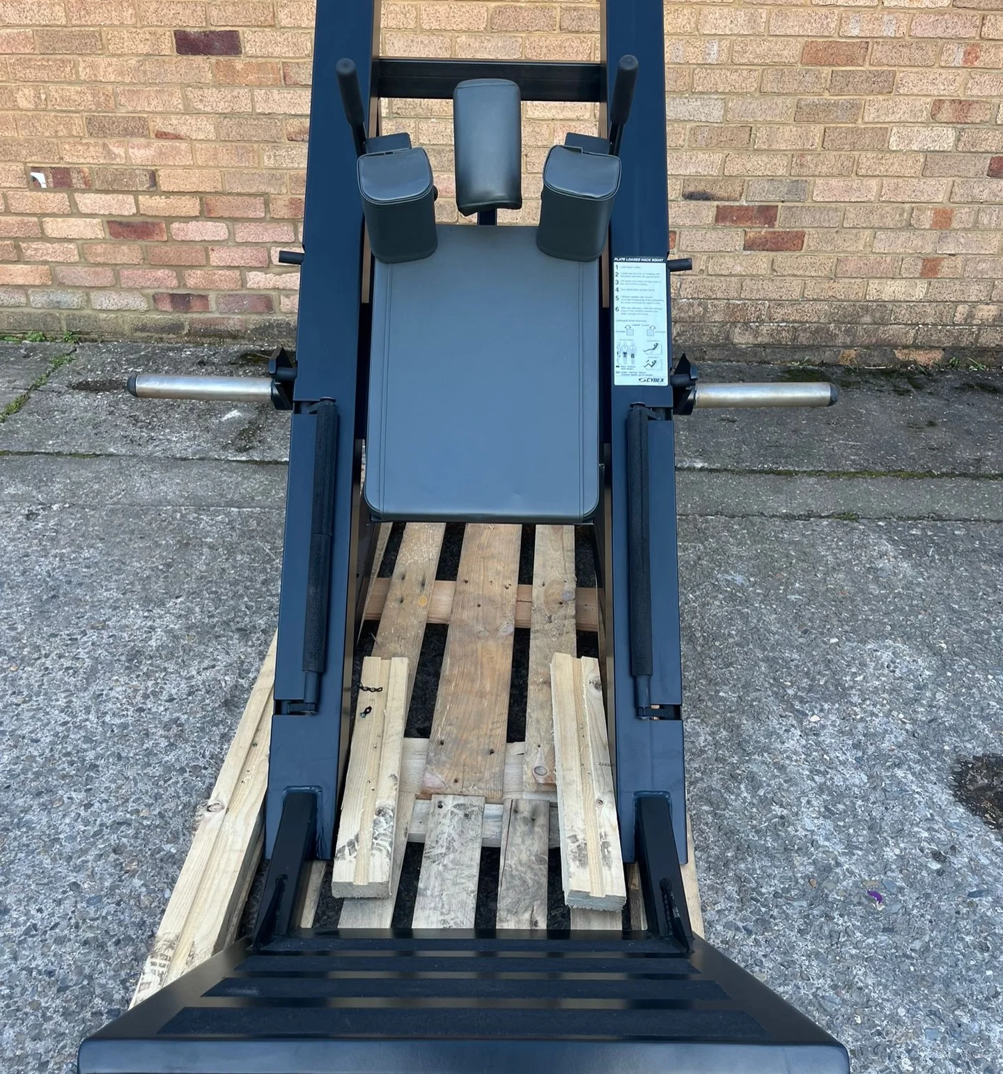Front view of the Cybex hack squat back pad, shoulder pads and footplate