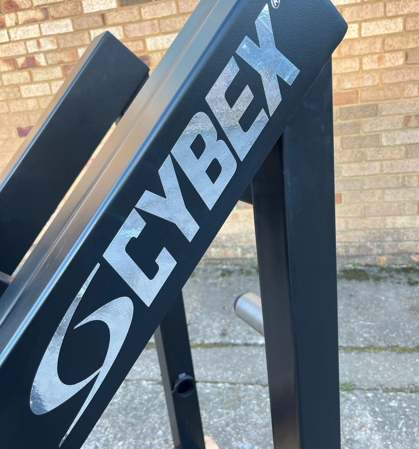Cybex logo on the hack squat frame upright